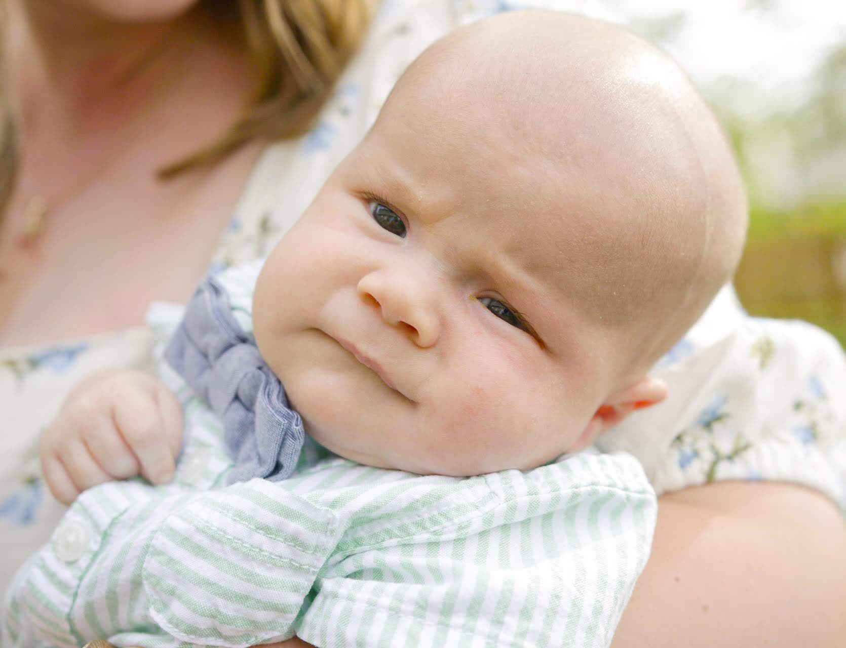 Baby boy held by Mom
