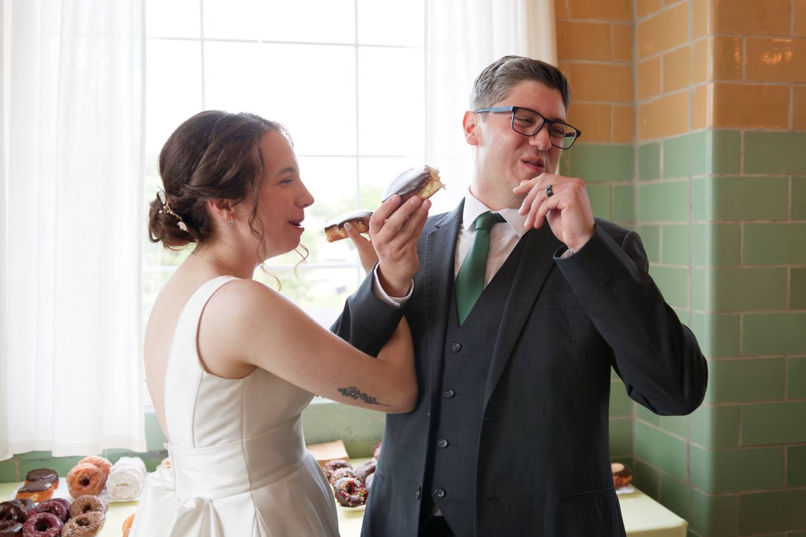 Bride and Groom eating Donuts at Wedding