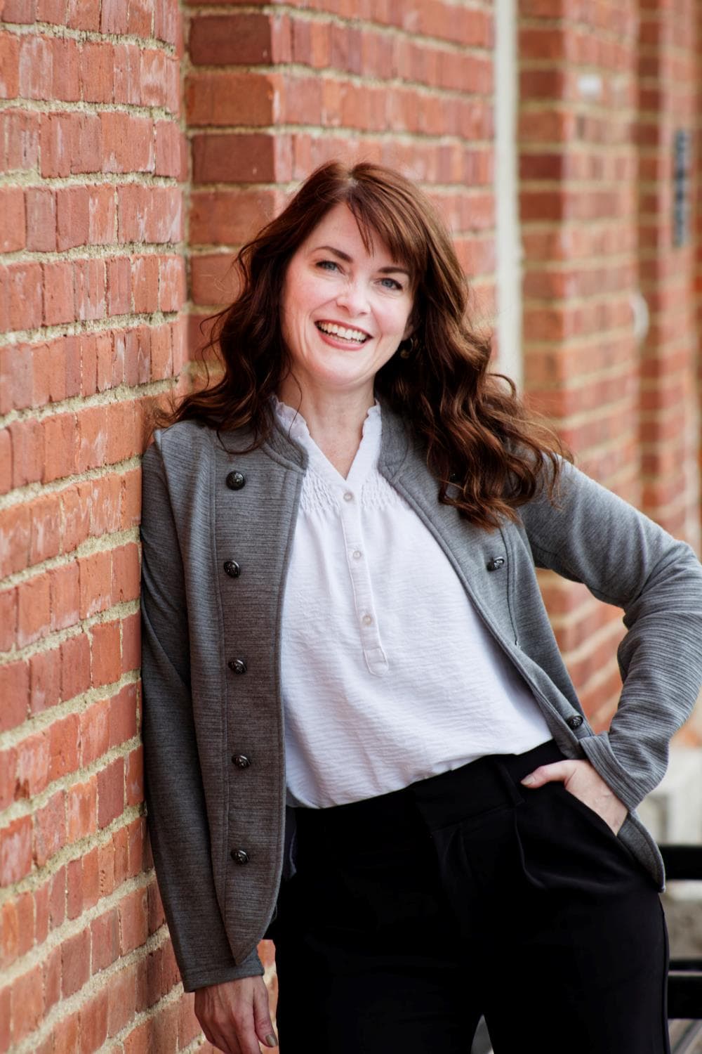 Pro Headshot Leaning on Brick Wall